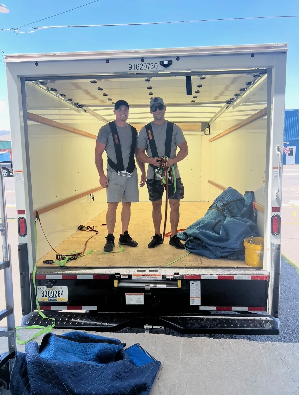 Good Guys Moving crew standing inside a loaded moving truck